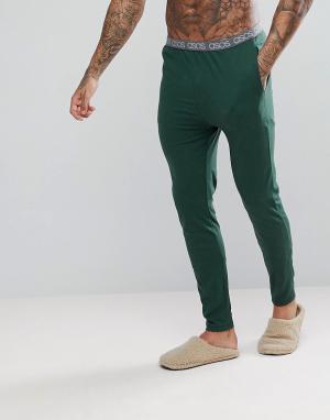 Трикотажные пижамные брюки узкого кроя с фирменным поясом ASOS. Цвет: зеленый