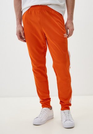 Брюки спортивные adidas Originals SST TP. Цвет: оранжевый